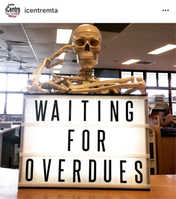 Screenshot of iCentre Mt Alvernia's Instagram account, image of a skeleton with a sign saying "Waiting for Overdues"