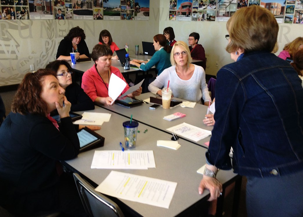 A group of librarians sitting around a table collaborating.