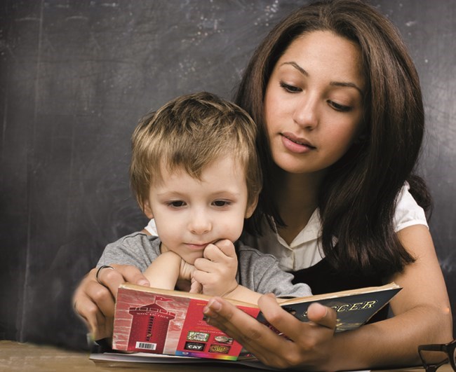 Woman and child reading a book together