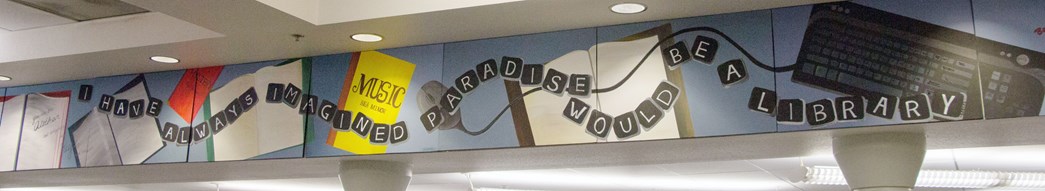 A display in a library: "I have always imagined paradise would be a library."
