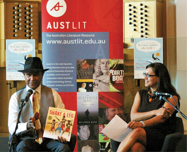 Boori Monty Pryor with Dr Anita Heiss presenting on stage together at BlackWords Symposium 2012.