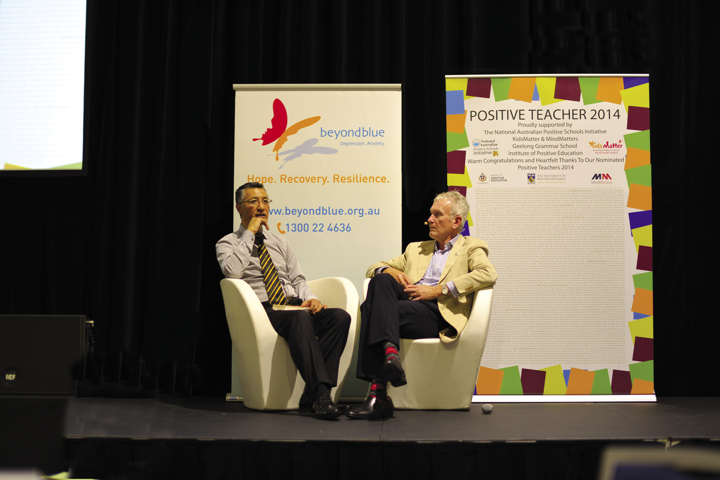 Andrew Fiu with Peter Thompson having a discussion on stage at a Positive Schools Conference, Sydney
