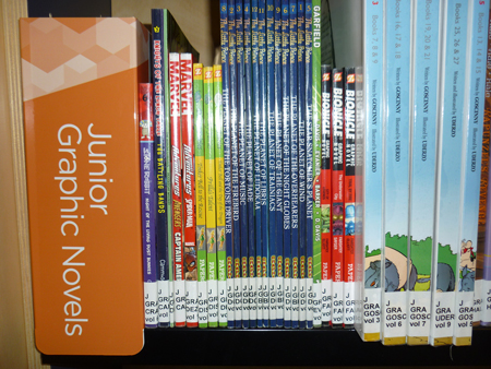 Junior Graphic Novels section on a bookshelf in a library