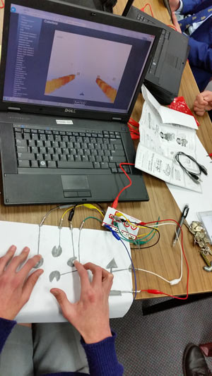 A substitute keyboard created with blank paper, lead pencils, wires and a laptop.