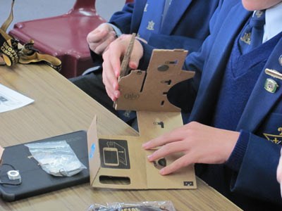 Students making a virtual reality headset out of cardboard.