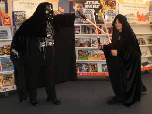 Two librarians dressed up as Darth Vader and the Emperor.