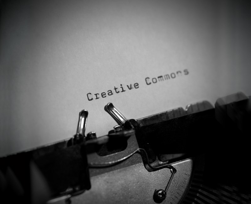 Close-up black and white photo of 'Creative Commons' typed on a piece of paper using a typewriter.
