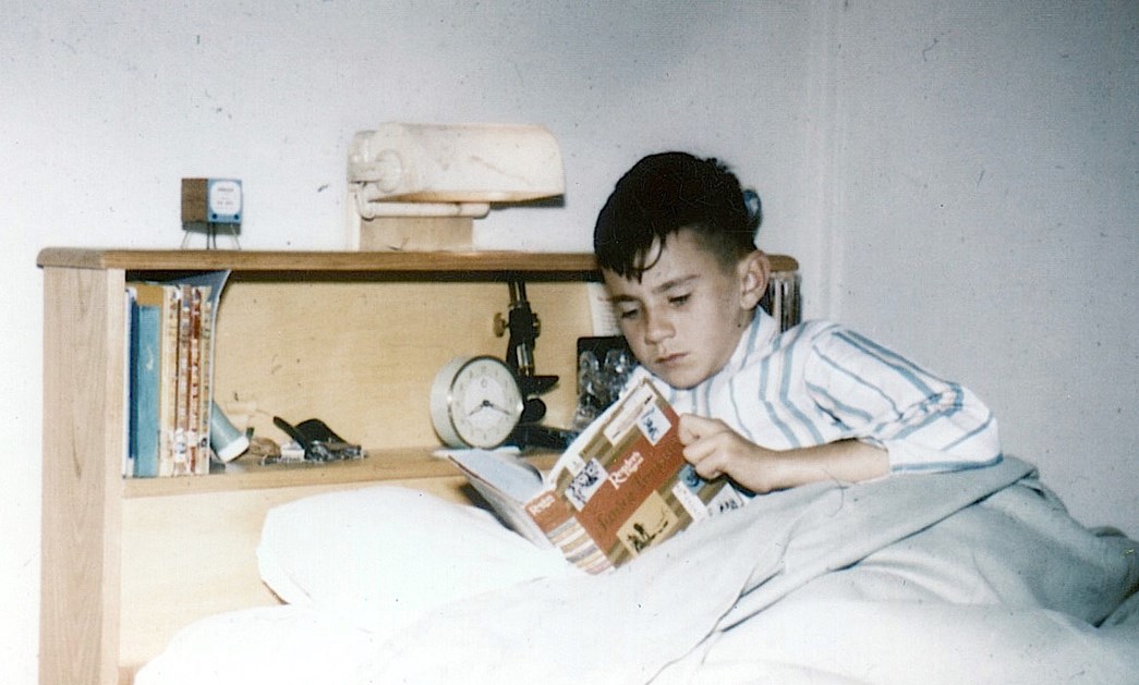 Leigh Hobbs as a child reading a book in bed