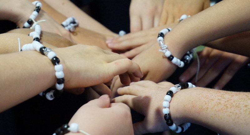 Children wearing binary bracelets