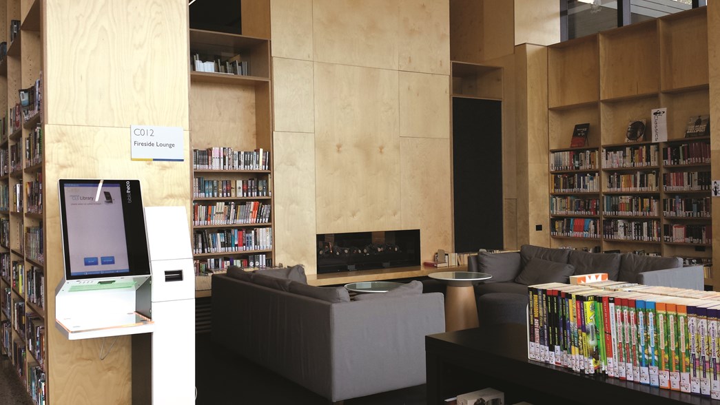 Lounges in front of a fireplace at one of the Casey Baptist Grammar College Libraries