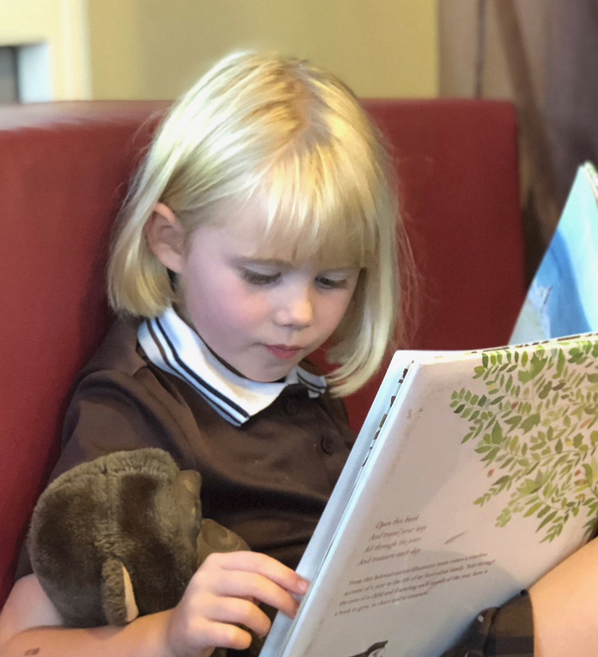 Child reading children's book,  'All Through The Year'