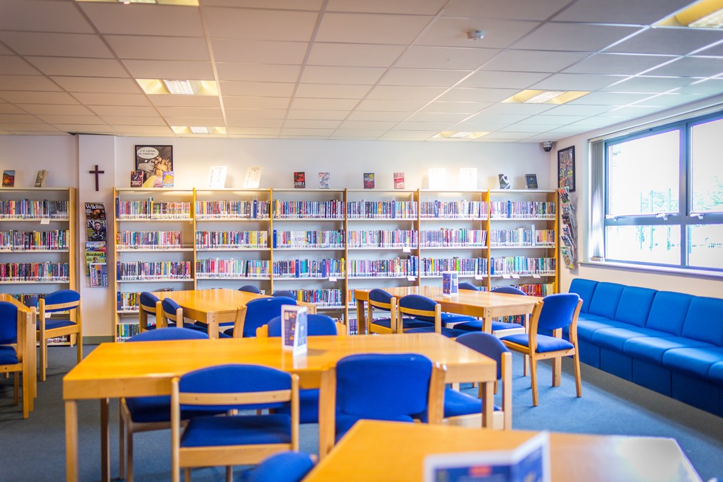 School library with bookshelves and tables and chairs