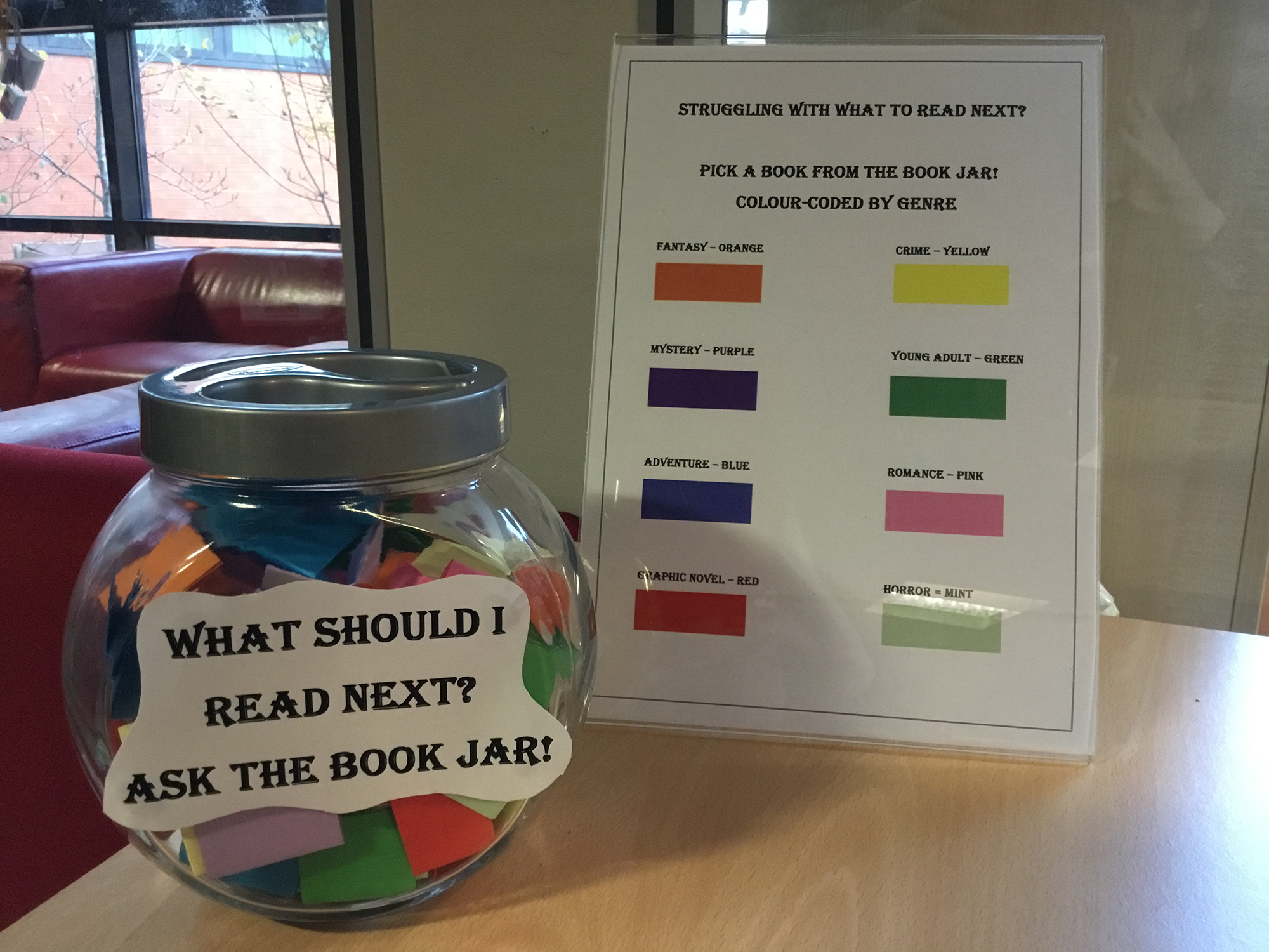 What Should I Read Next Book Jar on table with legend of what each colour means