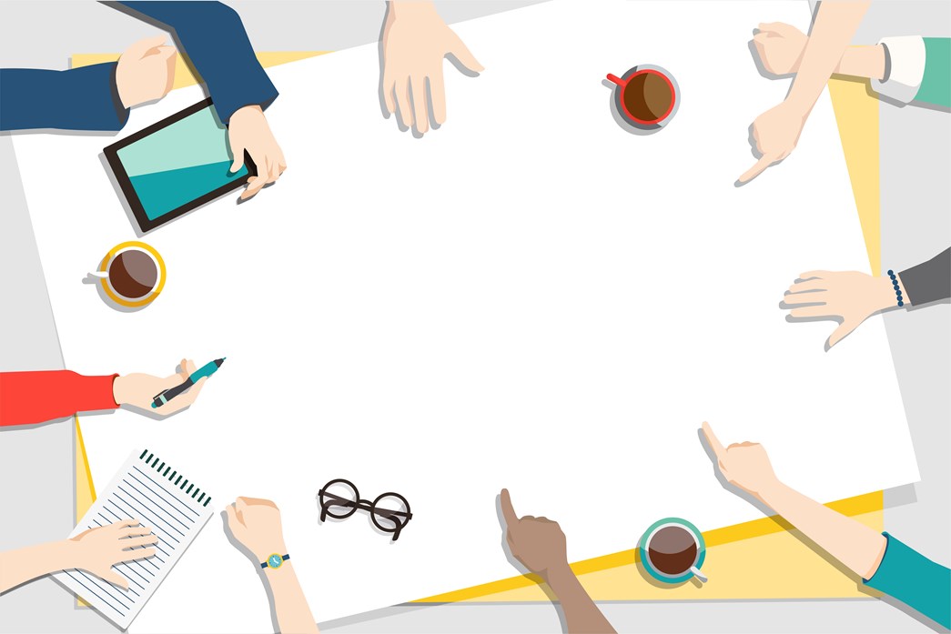 A group of people around a table working on a project