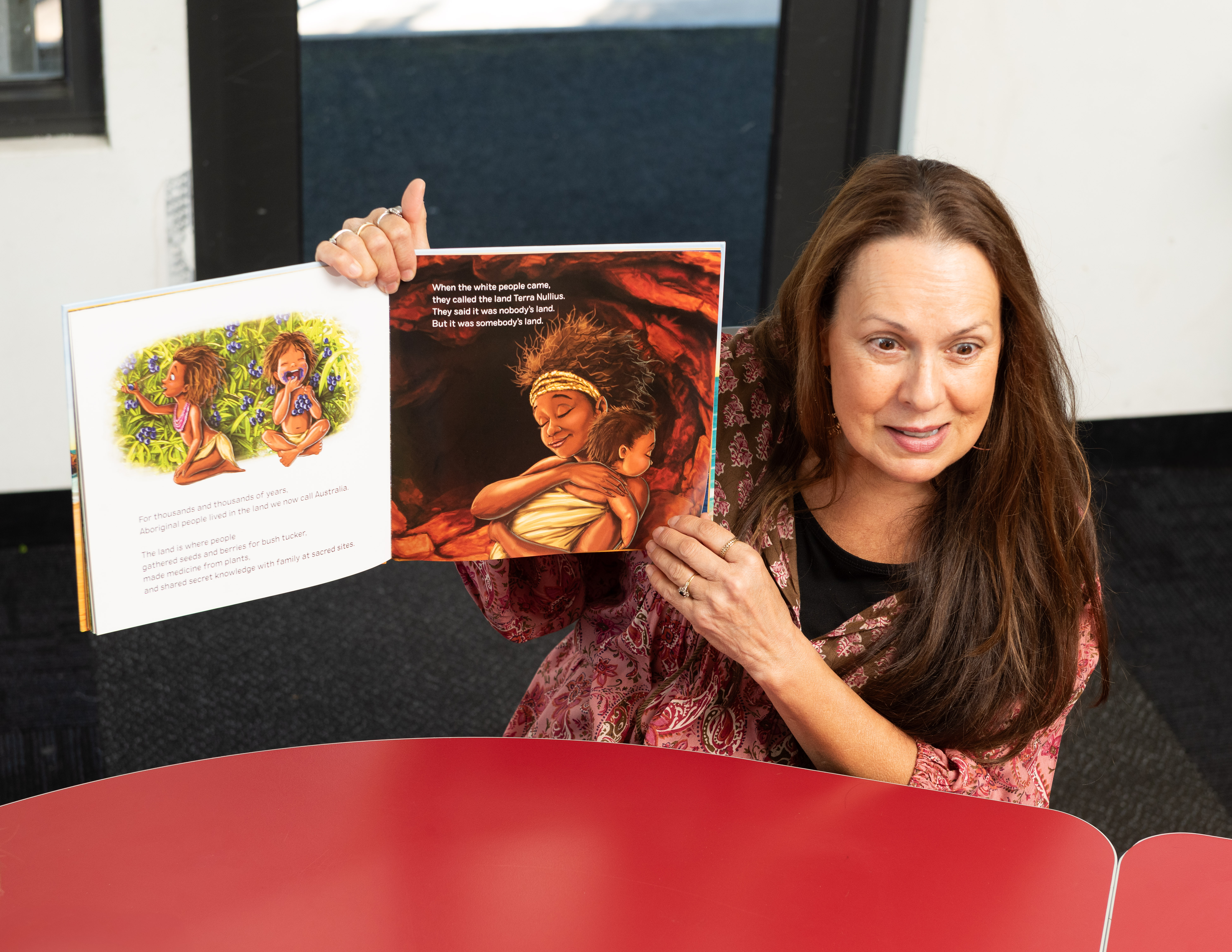 A teacher reading a picture book aloud