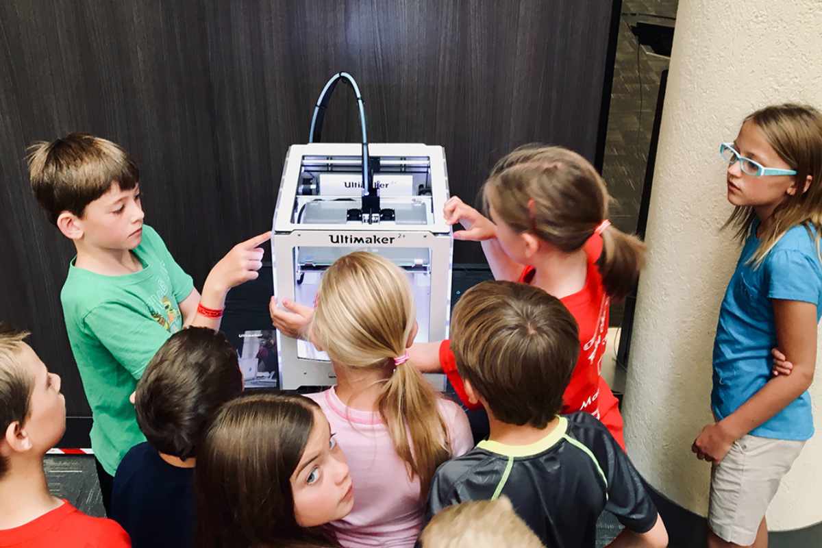 students using 3d printer in stem class