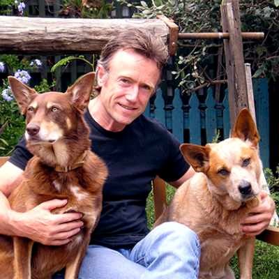 Paul Collins author profile picture with dogs