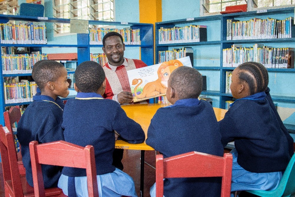 Mr Forehead, a primary library teacher, reads to some of his youngest students.