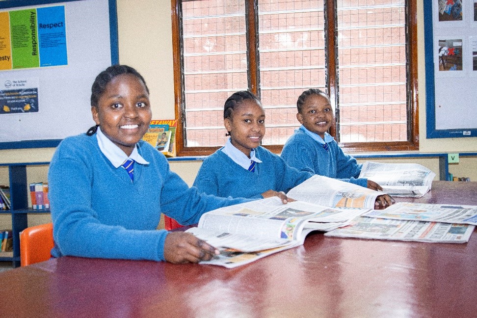 Students from St Jude’s Girls’ Secondary School catch up on the news during lunch time.