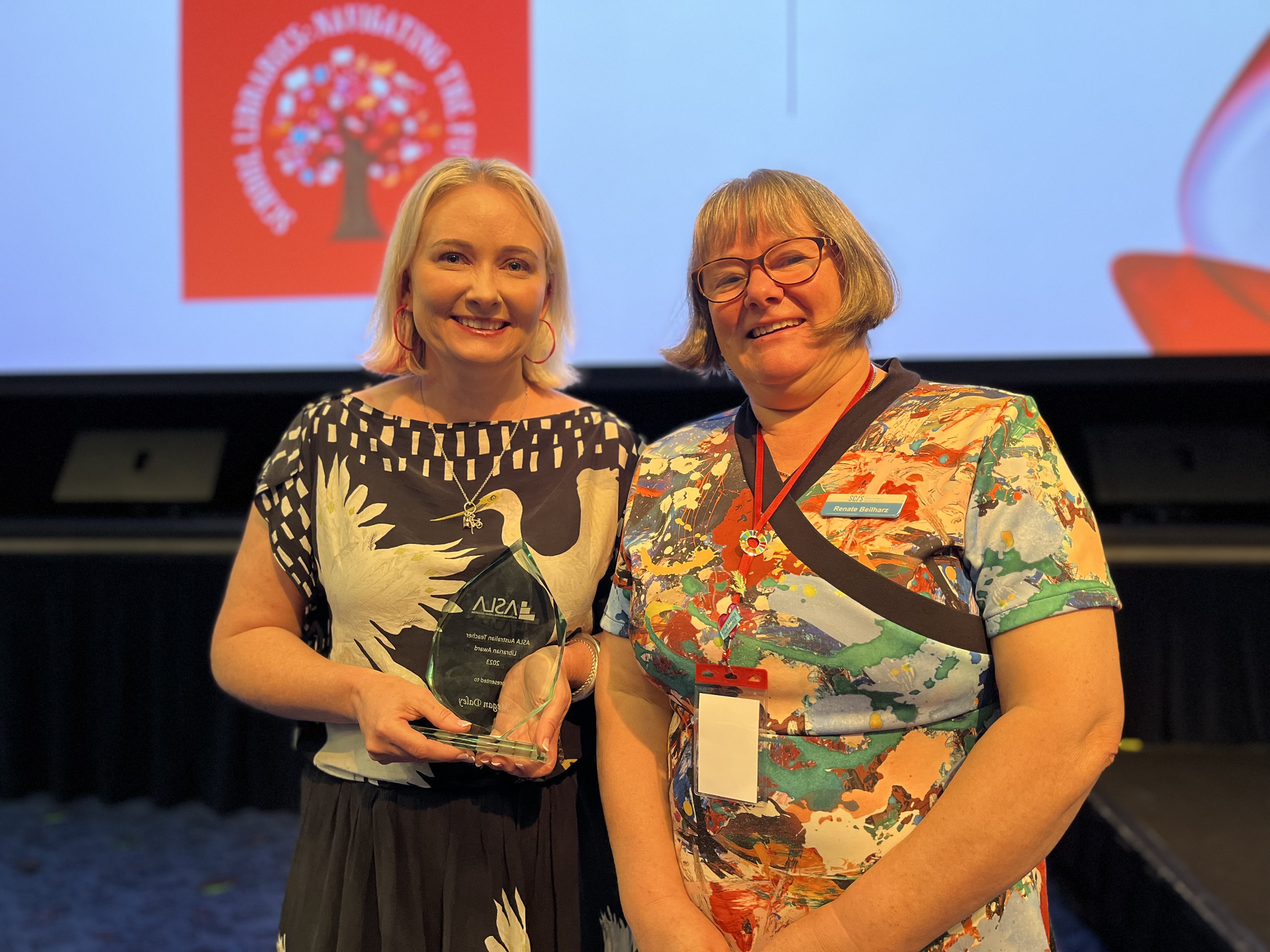 SCIS Catalogue Content Manager Renate Beilharz presents Megan Daley with the ASLA Teacher Librarian Award.