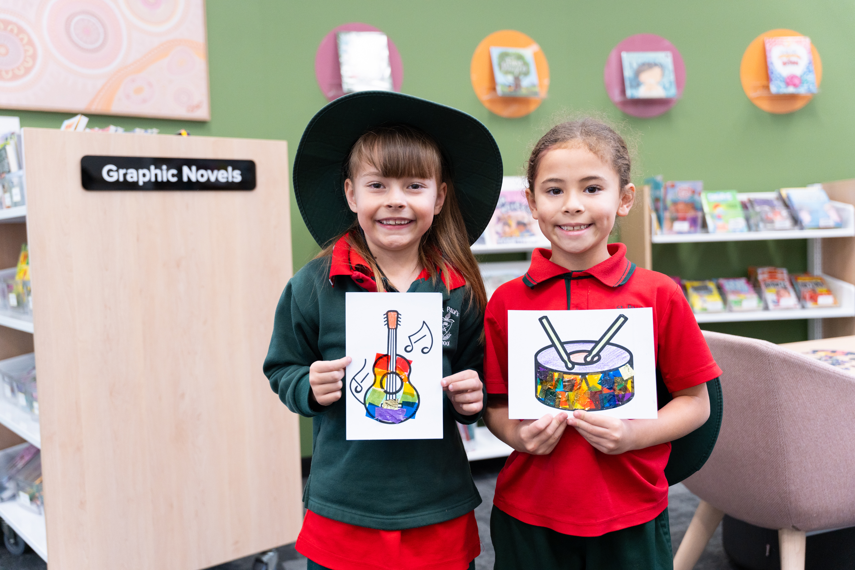 Students proudly holding up their completed work