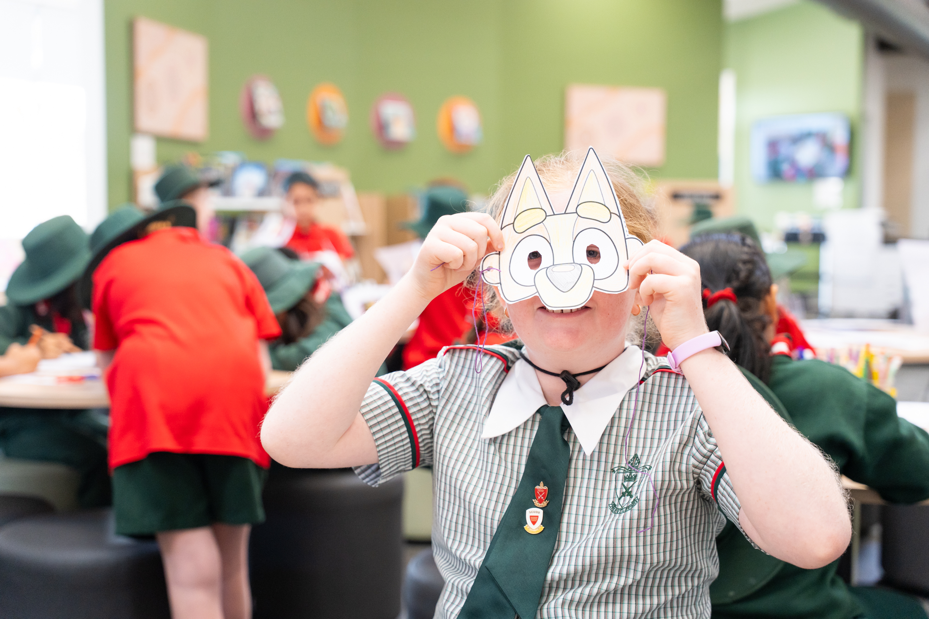 A students with a book week character mask they made at school
