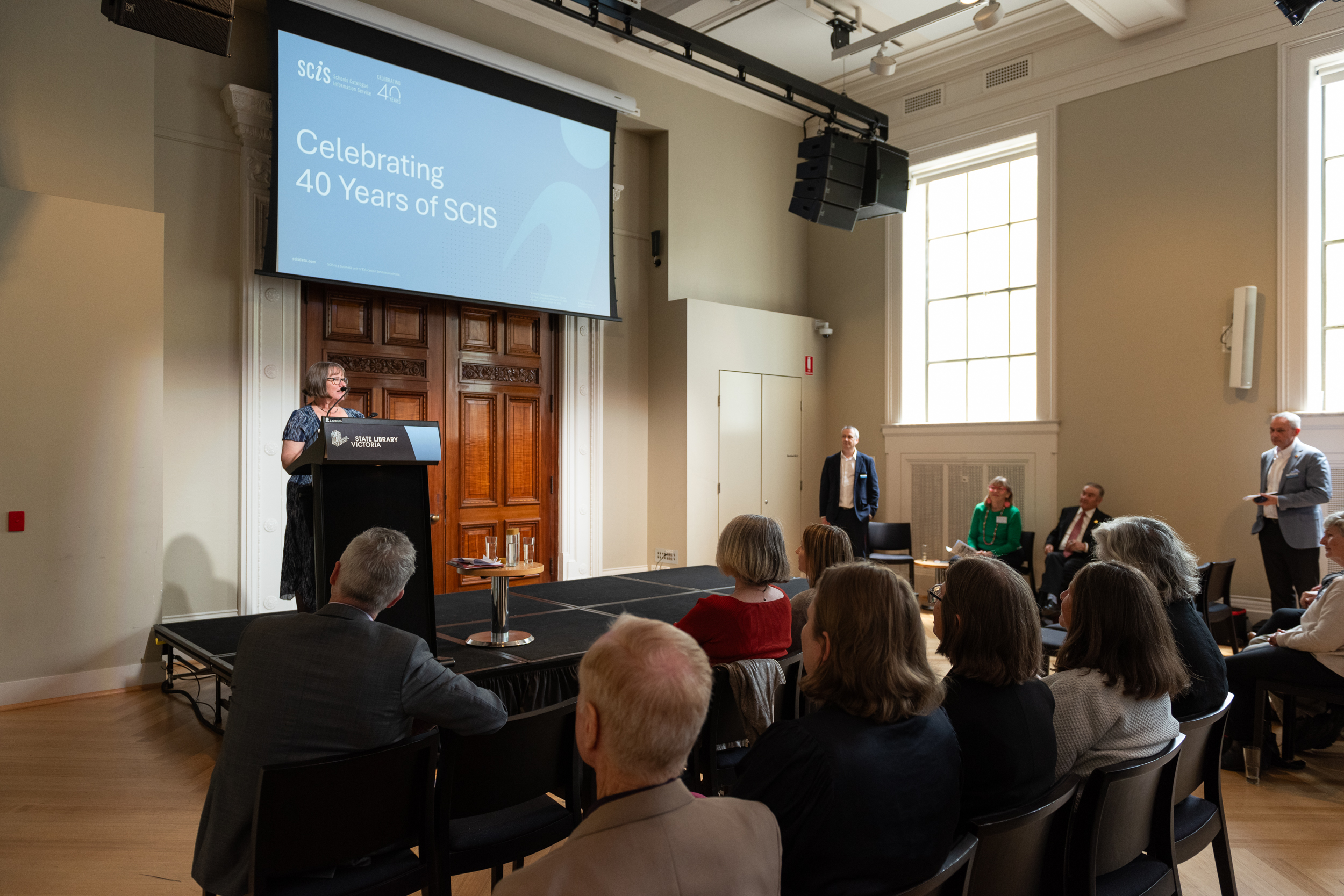 Renate presenting to a room of people